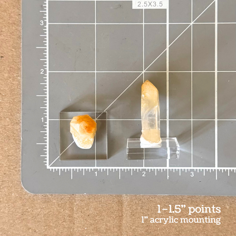 Labeled as one to one and a half inch points, with a one inch acrylic mounting. Scale image of two of the points on a measuring mat, one on its side with the point measuring about an inch and a quarter in length, and the other standing on its mounting, showing the acrylic mounting is one inch square