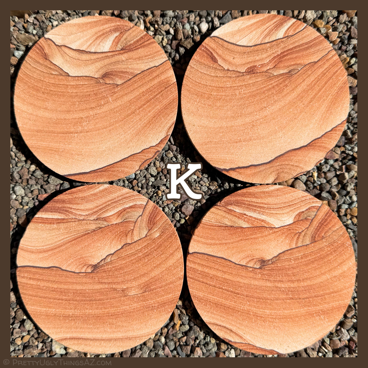 Option K, four coasters with thin light sweeping layers curved across the center, with thin dark iron bands along the sides with some scallop patterning.