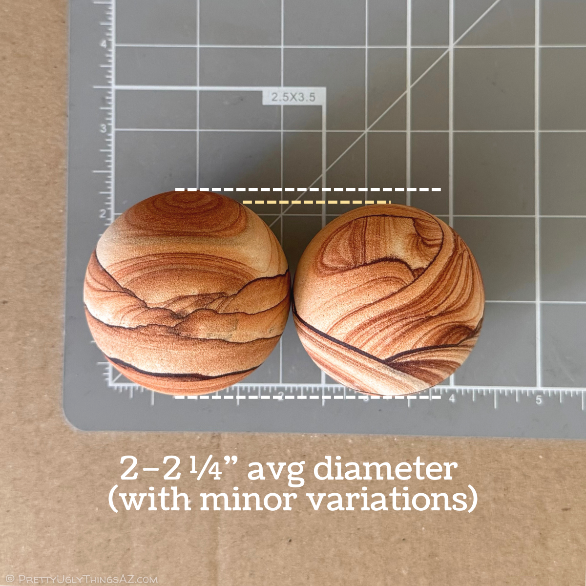 Two of the spheres on a measuring mat, the one on the left slightly larger than the other. The image is captioned two to two and a half inches average diameter, with minor variations. The larger sphere is about two and a quarter inches in diameter, and the smaller of the two is closer to two inches wide.