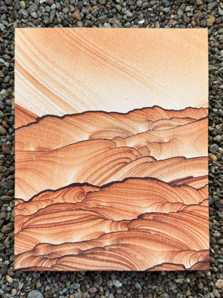 A large rectangular slab of sandstone oriented in portrait. It resembles a scene of a sunset over rolling hills. Bold and thin dark iron bands create several layers of hills with complex detailing, like the barren hills in a desert. They are filled with saturated layering, while the light-colored sky above has a gradient of near-white sandstone striped with light orange layers.