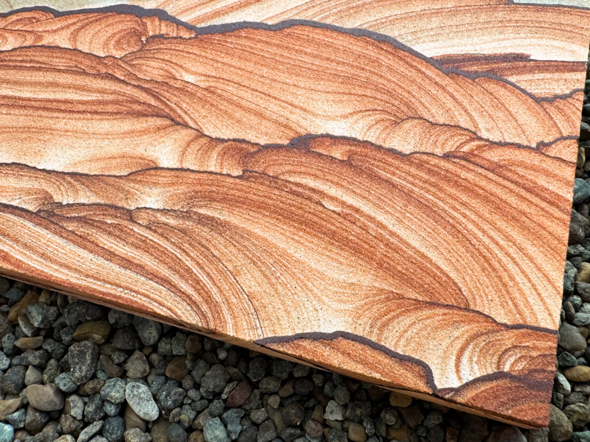 Close detail view of a corner of the slab, showing vibrant swirling layers of sandstone.