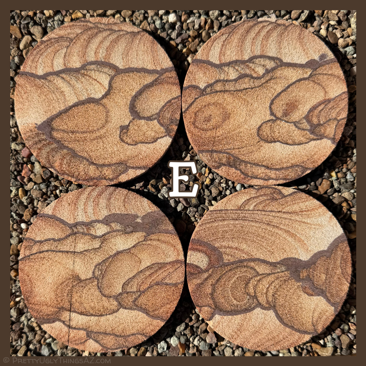 Option E, a set with excellent bubbly rounded forms and rings of color. Layers sweep across the top like sky, with round forms ringed in dark iron bands. There is a ridge across one coaster where it was cut unevenly.