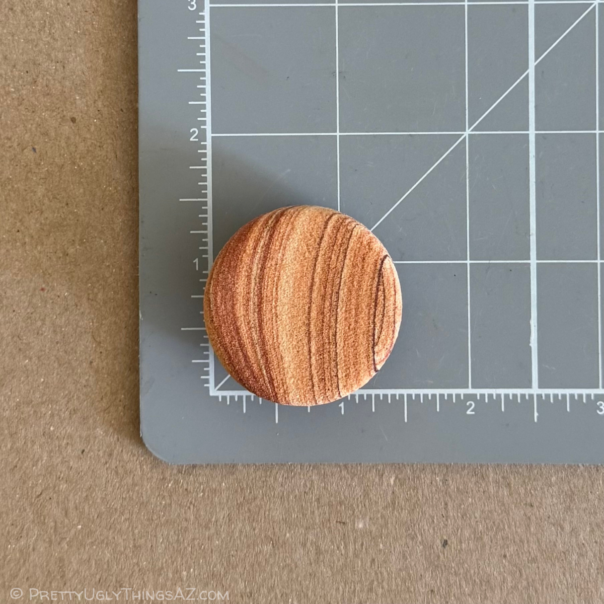 One of the magnets on a measuring mat, measuring a bit under an inch and a half in diameter.