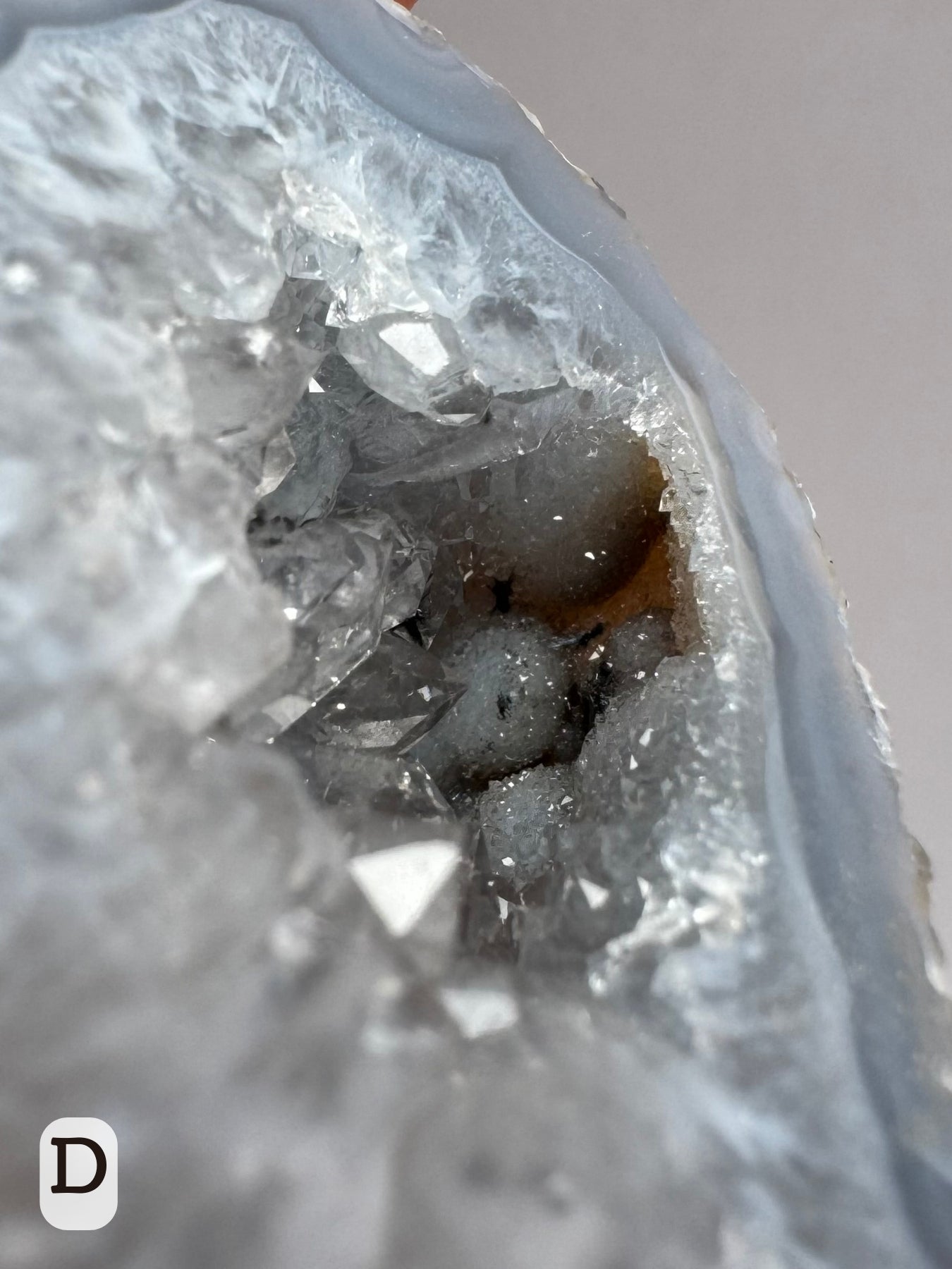 Option D: Detail of a pocket of botryoidal agate growth inside the geode, coated with fine druzy