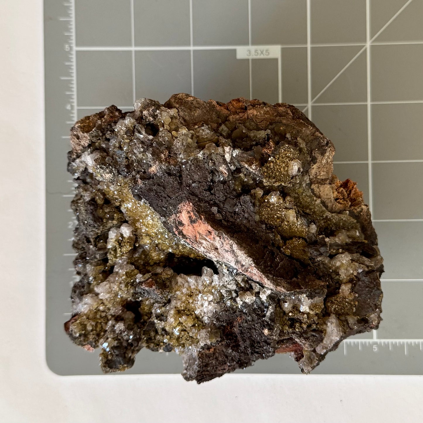 Scale image of the piece on a measuring mat, measuring about five inches wide and four inches tall