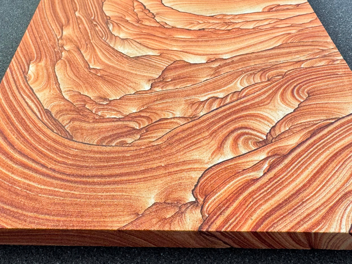Angled view looking up from the base of the slab, showing the edge is about a centimeter thick.