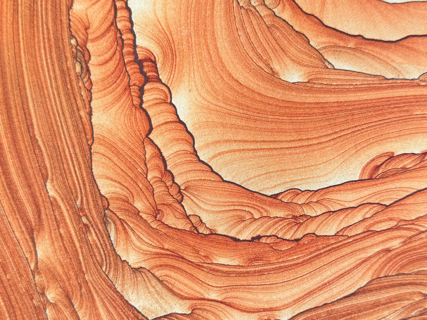 Close detail view of the top part of the surface, with a stack semi-circle pattern of layering through the middle and broad sweeping layers around it.