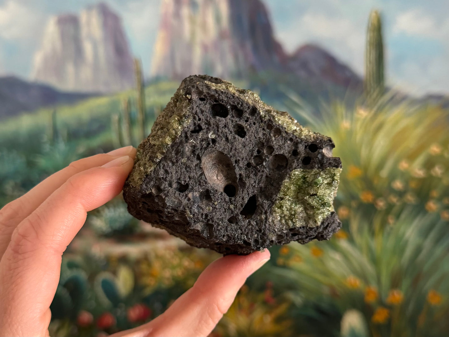 A side of the piece that is mostly volcanic rock with some good bubble hole pattern. There are patches of peridotite of varying quality on the sides.