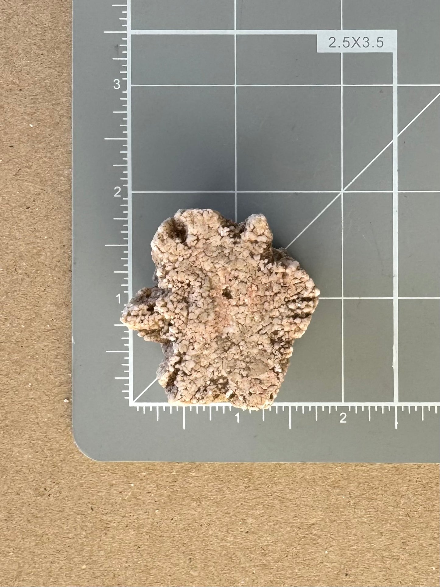 Scale image of the piece on a measuring mat, a bit over an inch and a half across