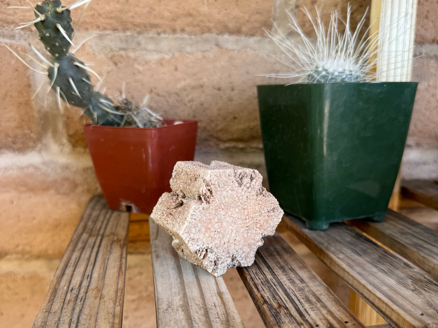 The piece on a shelf, a more distant view of it stood on edge and angled. The texture looks crackled from a distance