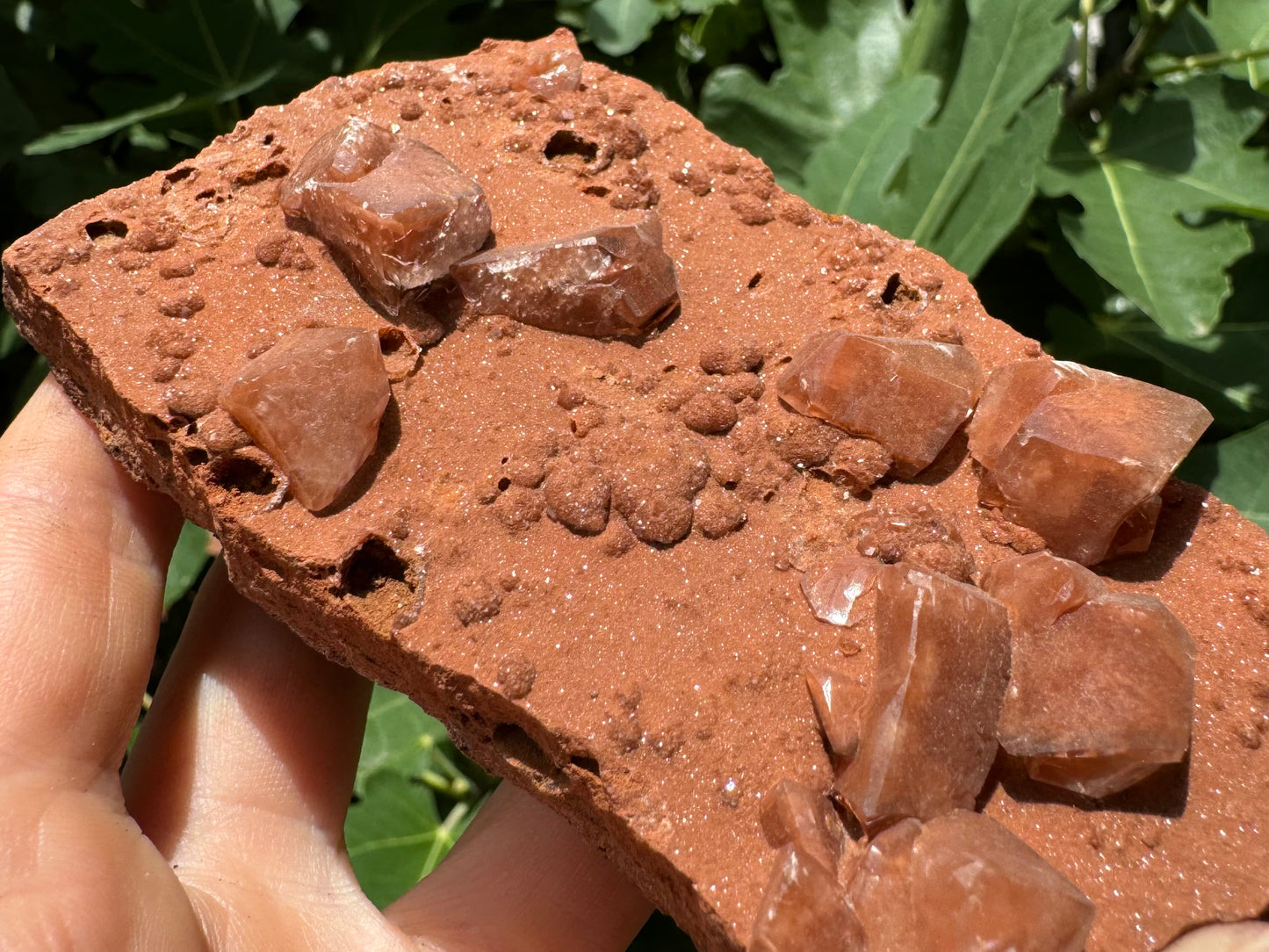 Detail view of the piece in the sun, showing the surface has a fine sandy glitter to it.