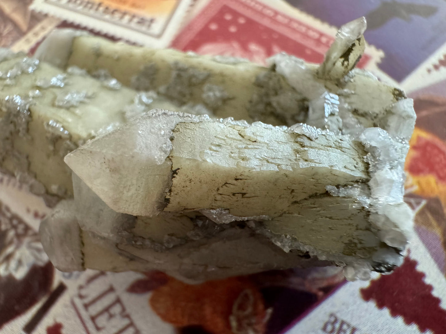 Detail of one of the smaller quartz points on the cluster, with excellent sprouting growth patterns on the faces. The tip of the crystal is thicker, whiter, and more translucent