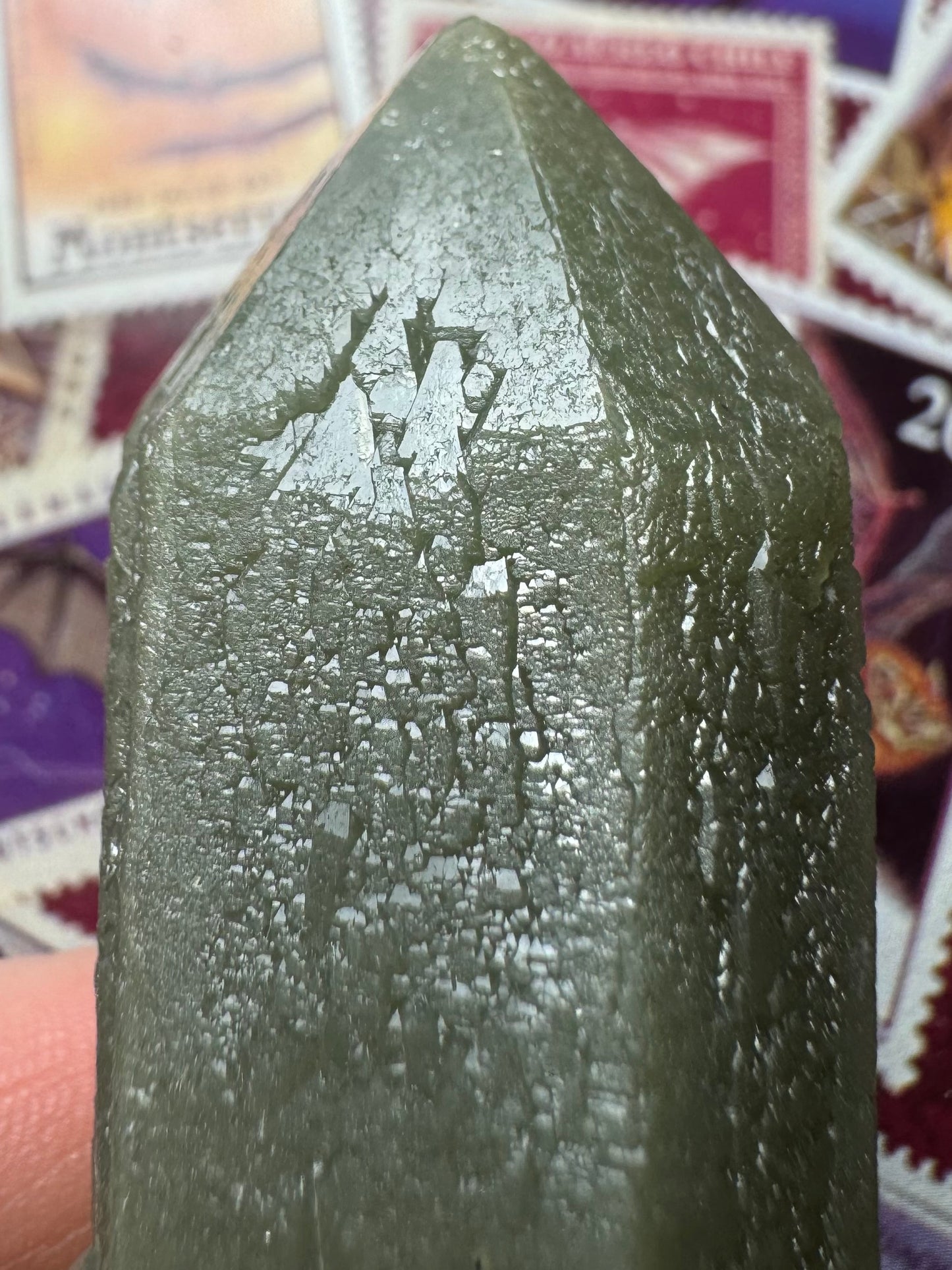 Detail of the tip of the point with light reflecting off it, highlighting the edges of faces are solidly formed but the center has skeleton-like growth caused by faces of the sprouting growth form.