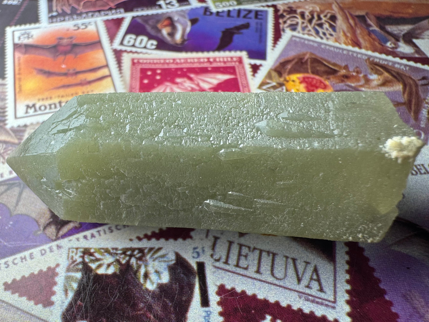 Two sides of the piece visible, each with several fairly large and three-dimensional sprouting growth crystals near the base.