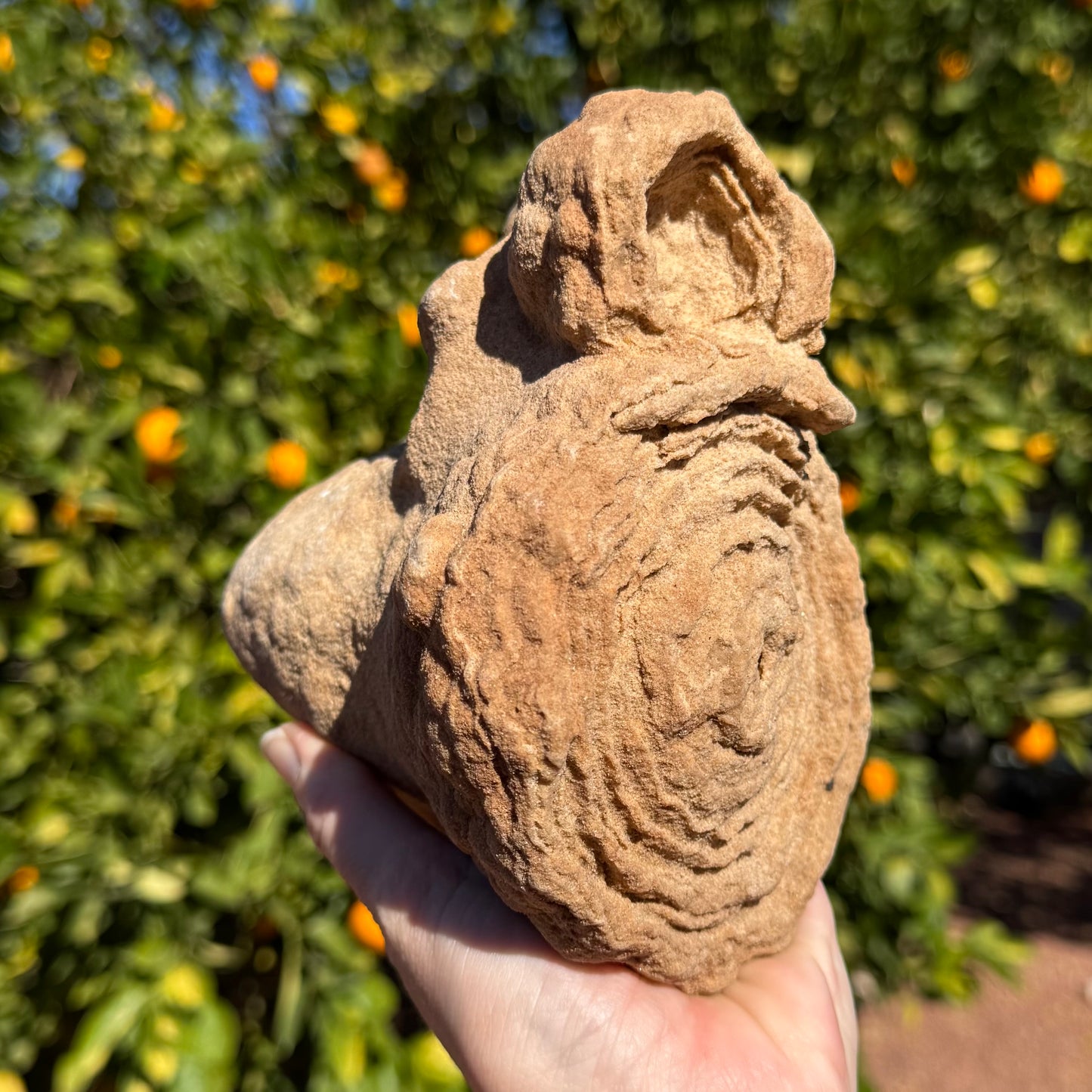 The piece on its side, the round faces in the foreground and pointed end sticking out behind.