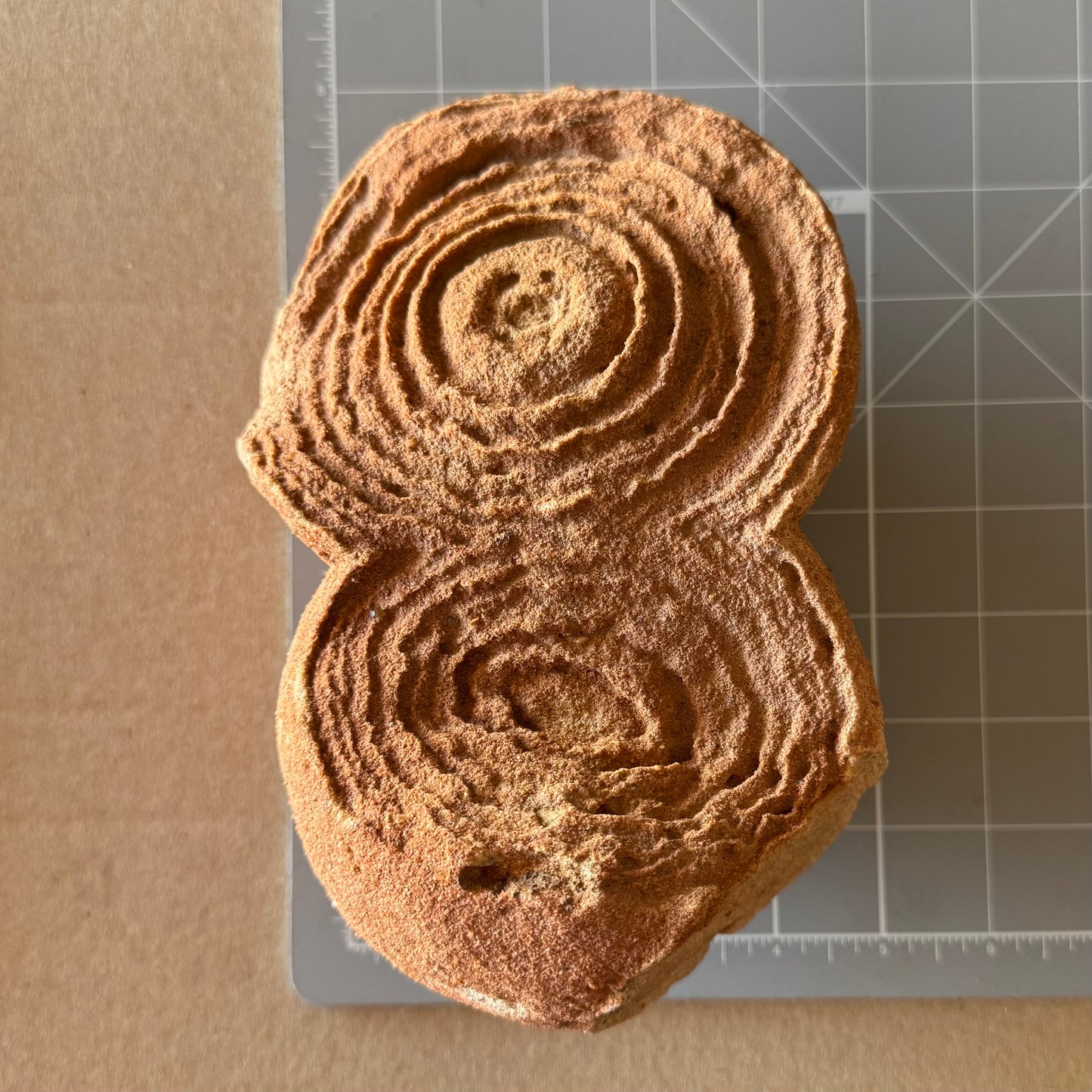The piece on a measuring mat, measuring about 7 inches long and almost five inches wide