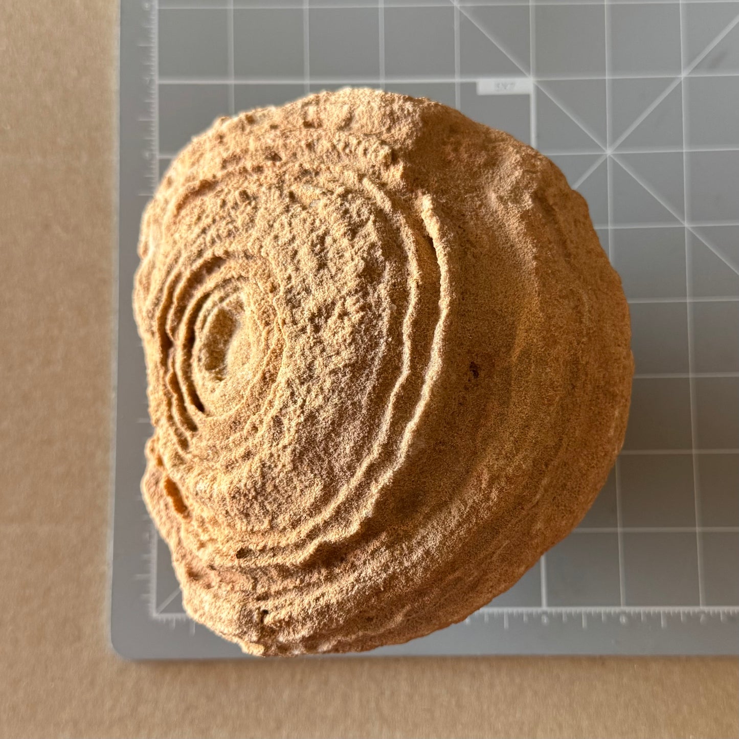 Scale image of the piece on a measuring mat, measuring a bit over five inches square.