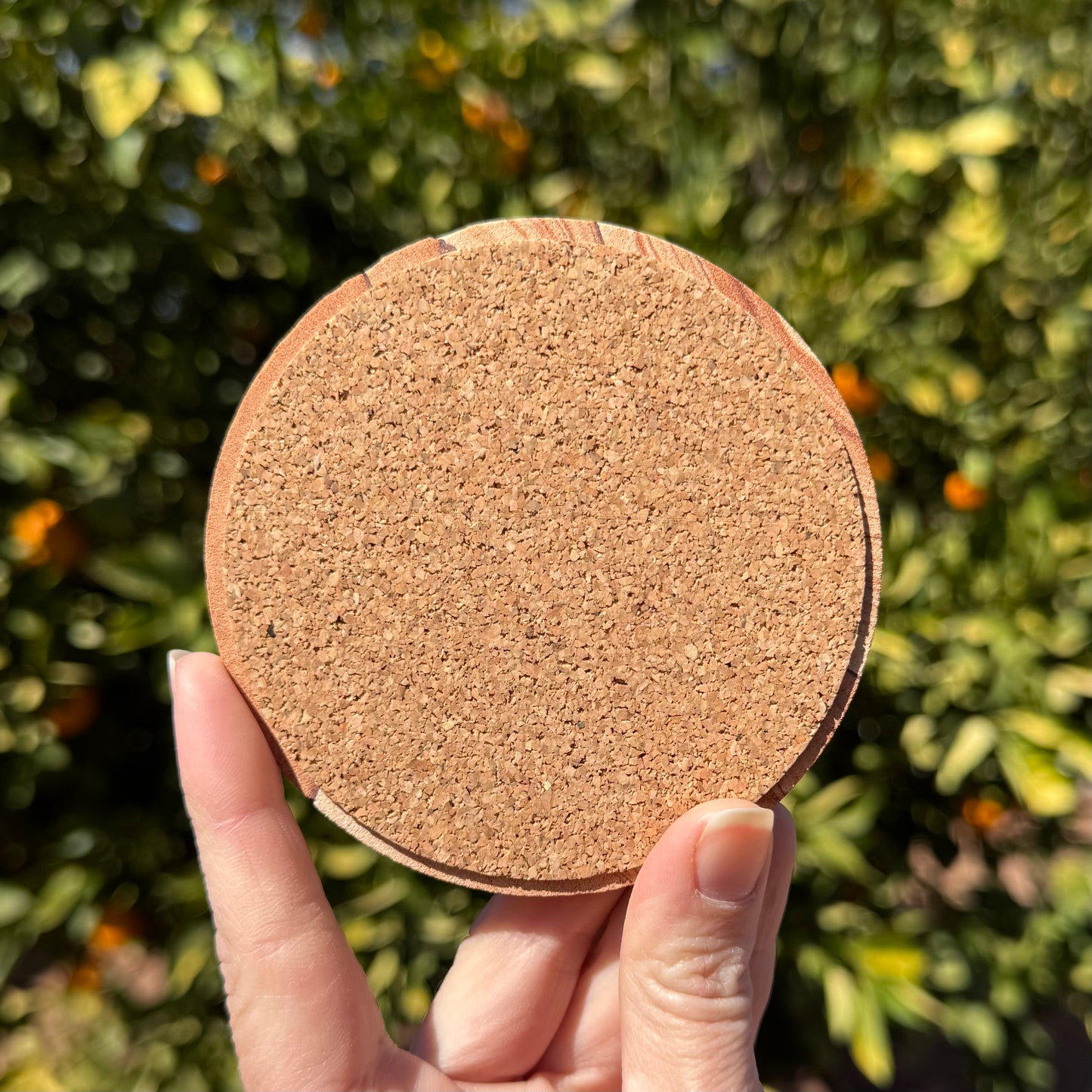 The back of the coaster, covered with a thin layer of cork padding.