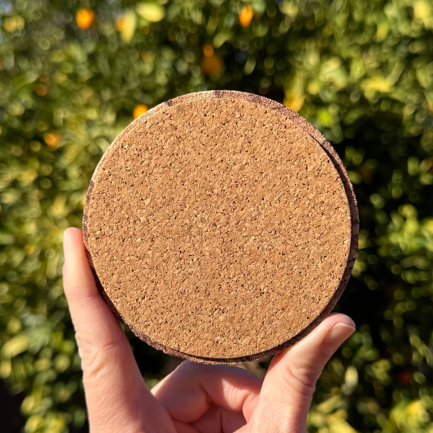 The back of the coaster, covered with a thin layer of cork padding.