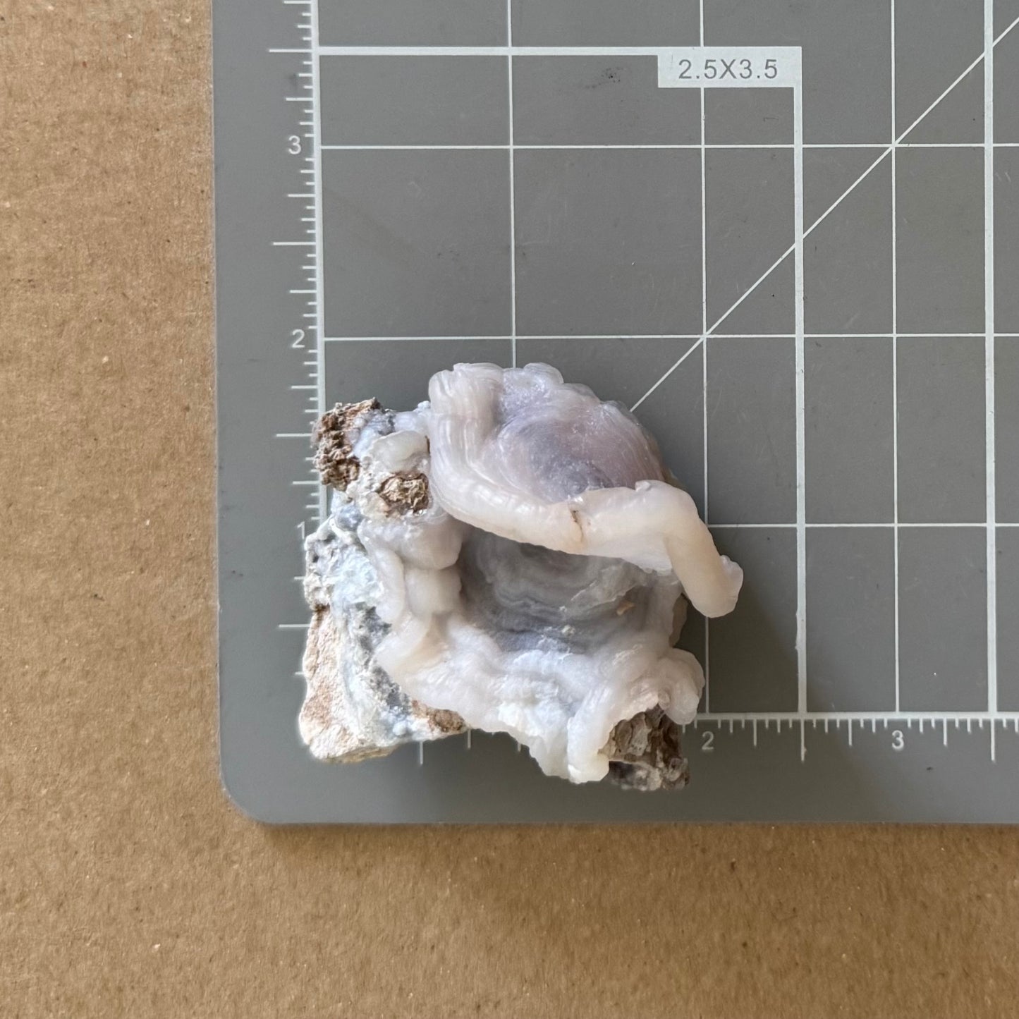 The piece on a measuring mat, measuring about two inches square.