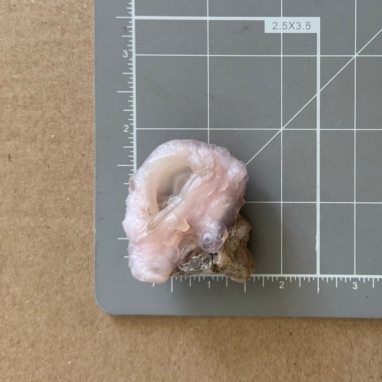 The piece on a measuring mat, measuring about an inch and a three quarters in diameter.