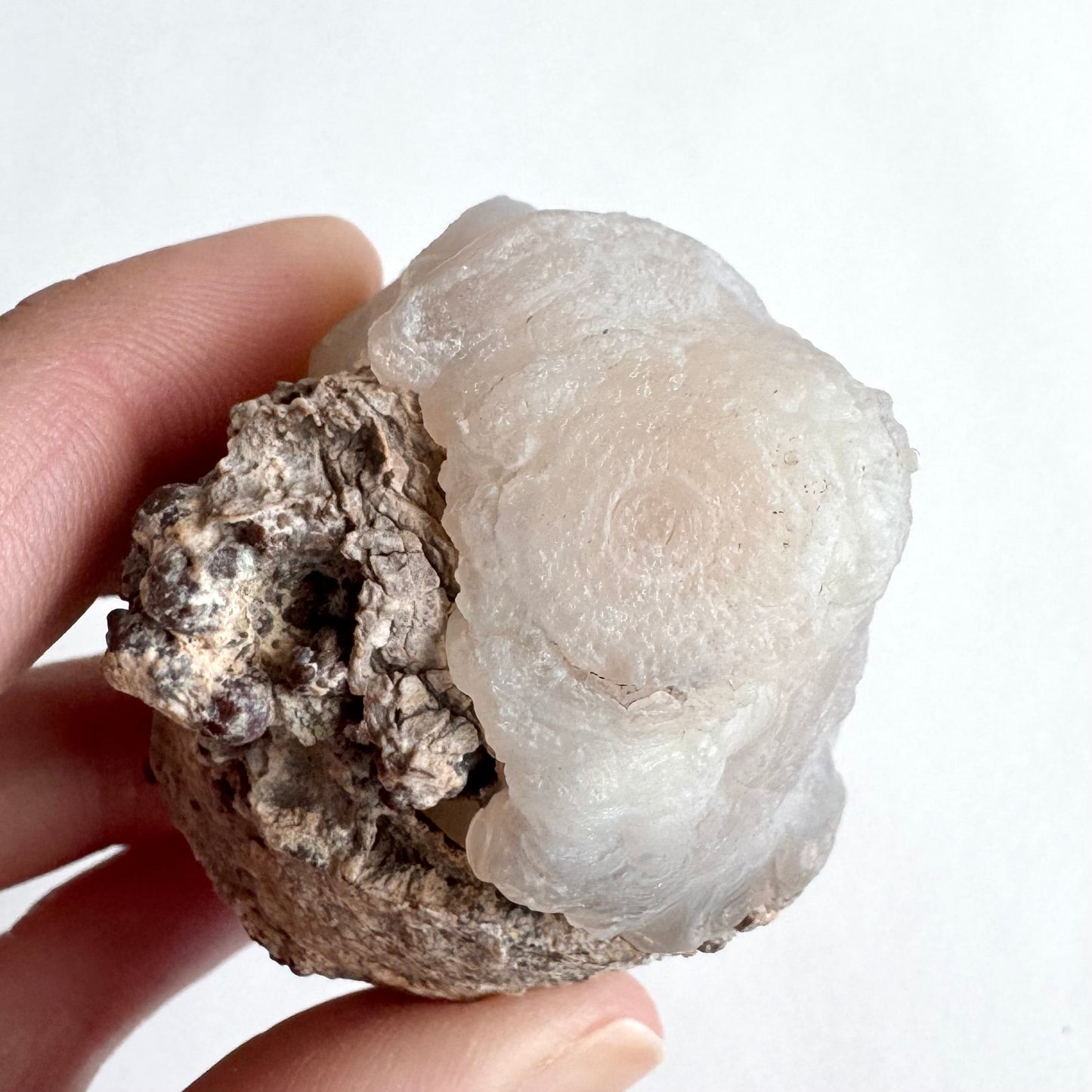 A closer view of the banding on the reverse of the specimen, with faint agate rings visible.