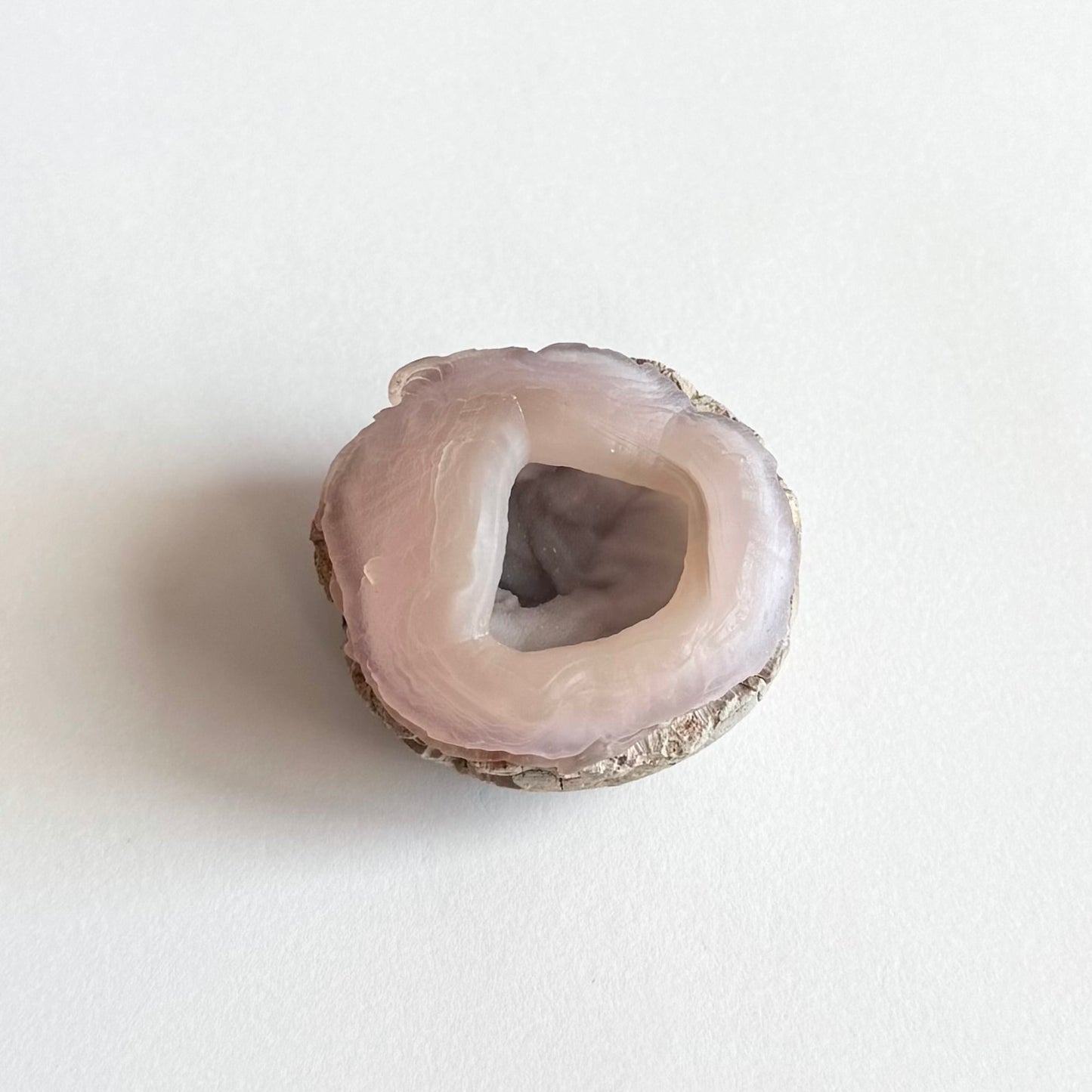 A more distant view of the piece, the interior shaded but with some glow of light coming through the translucent chalcedony.