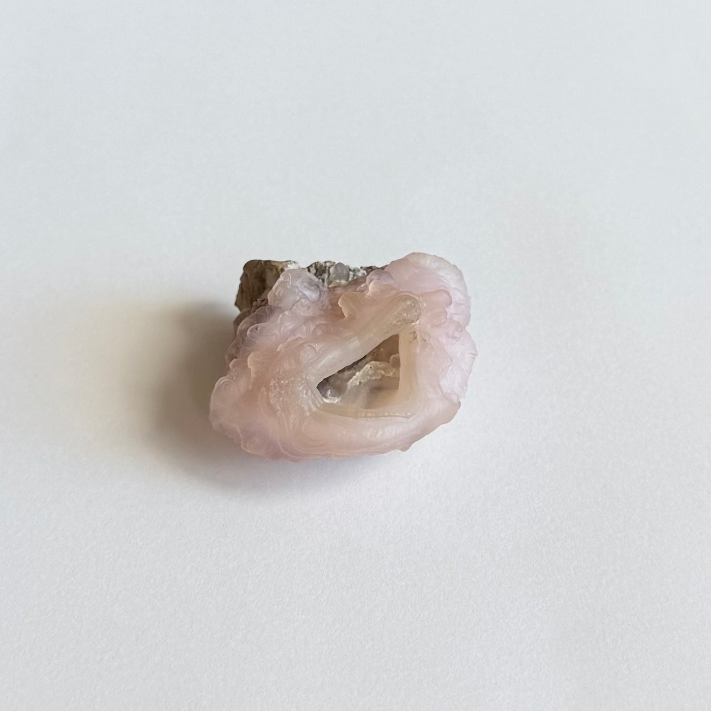A more distant view of the piece, the interior shaded but with some glow of light traveling through the translucent chalcedony.