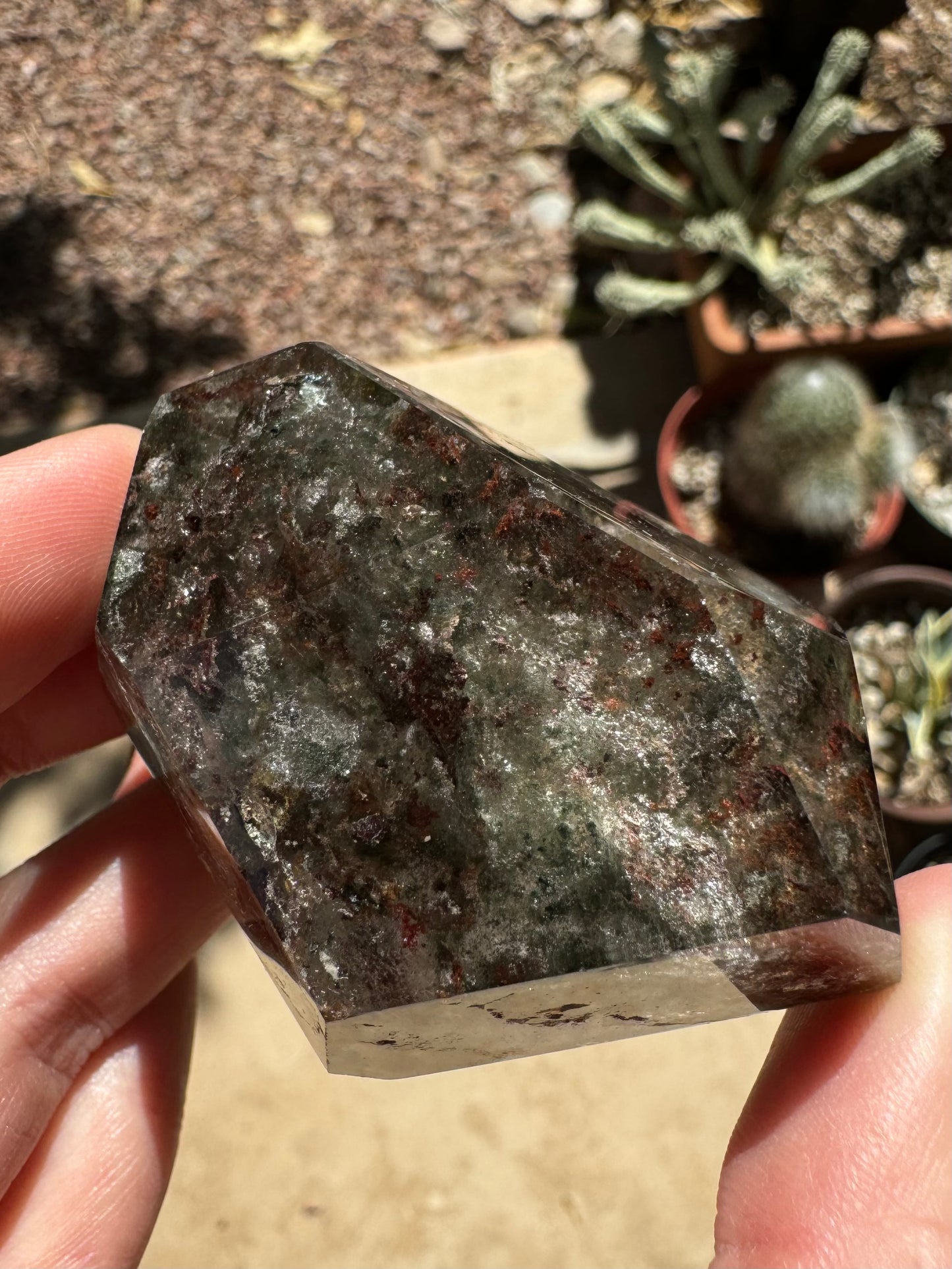 The piece held down with light shining on it, showing darker pattern that seems more opaque without back-lighting.