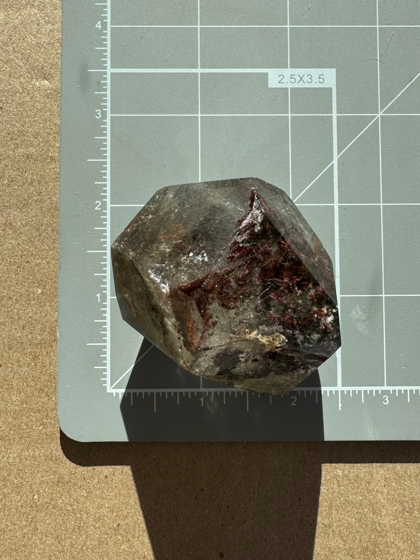Scale image of the piece on a measuring mat, measuring about two inches long by a bit under 2 inches wide.