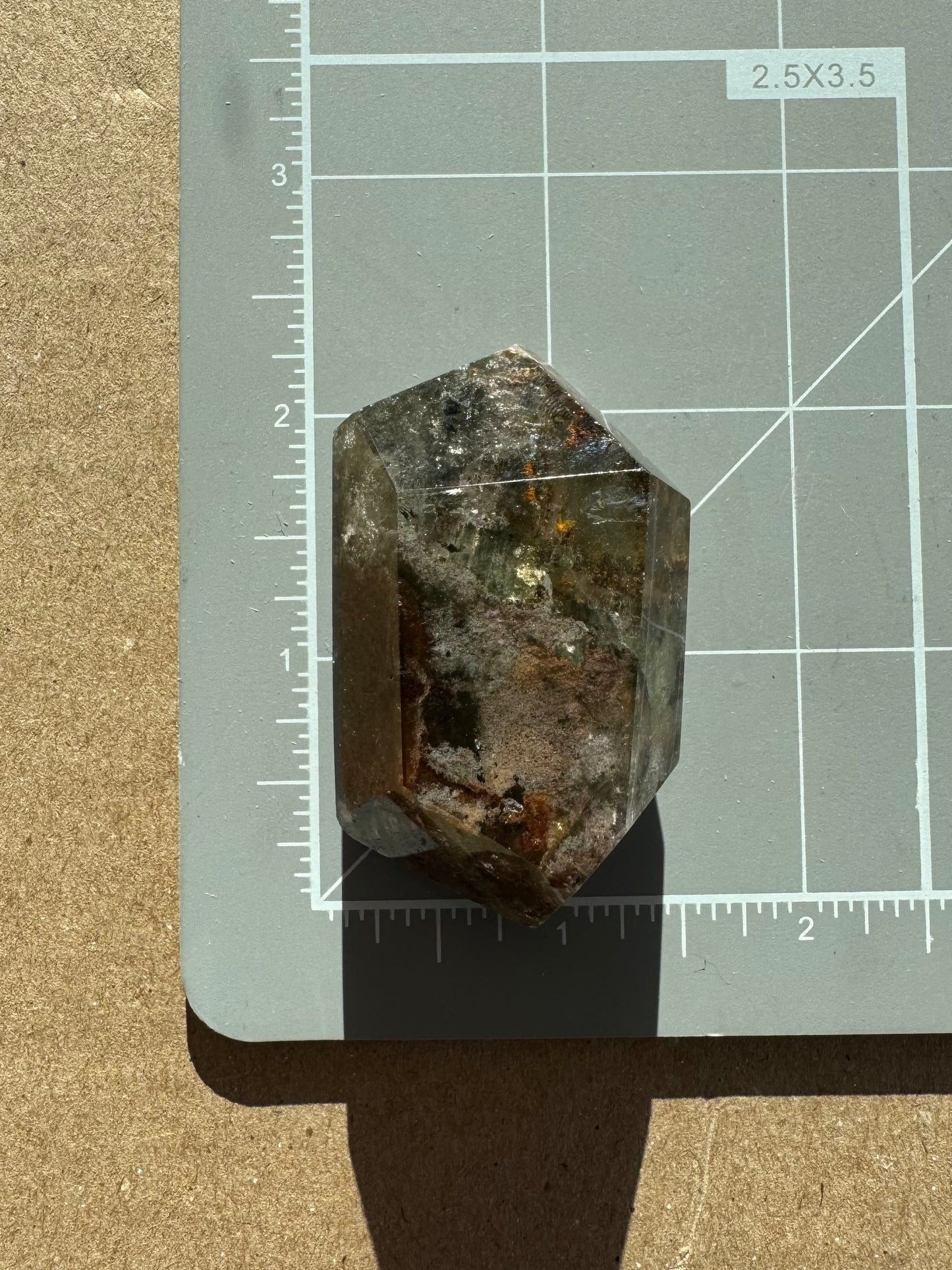 Scale image of the piece on a measuring mat, measuring about two inches long by an inch wide.