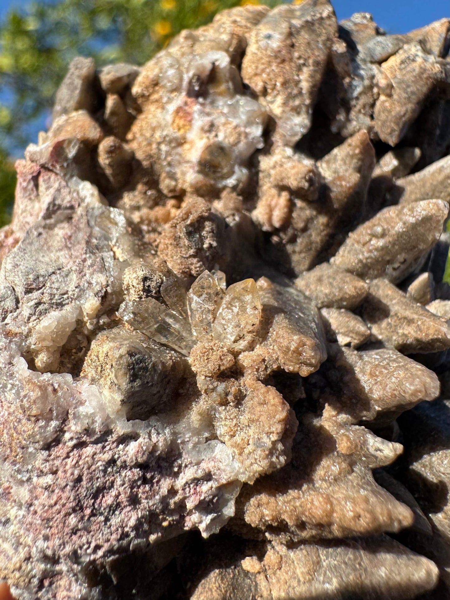 Detail of a cluster of five tiny quartz points on the piece, where the calcite points meet matrix on one edge.
