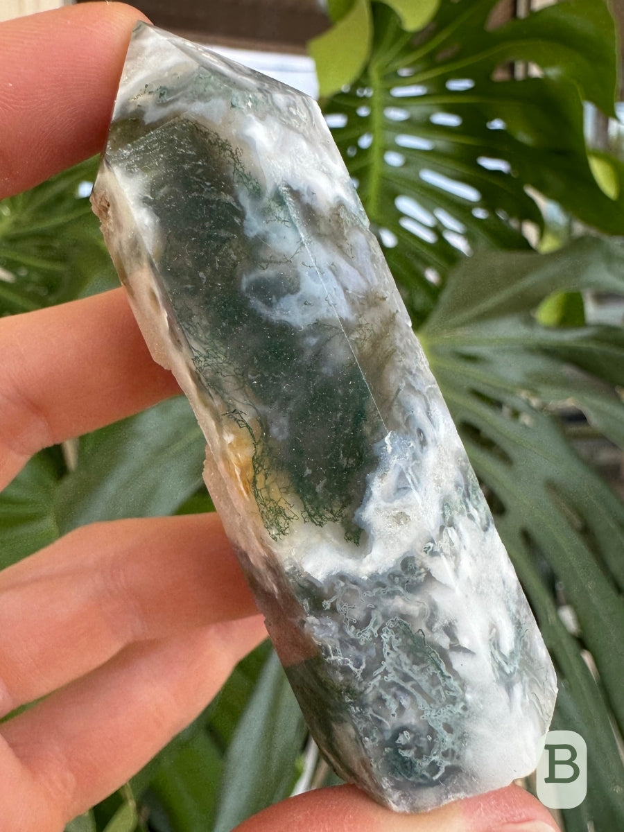 Option B, detail of the thick band of green, showing the inclusions are thin and wispy. The base of the tower has swirling white, green, and translucent agate.