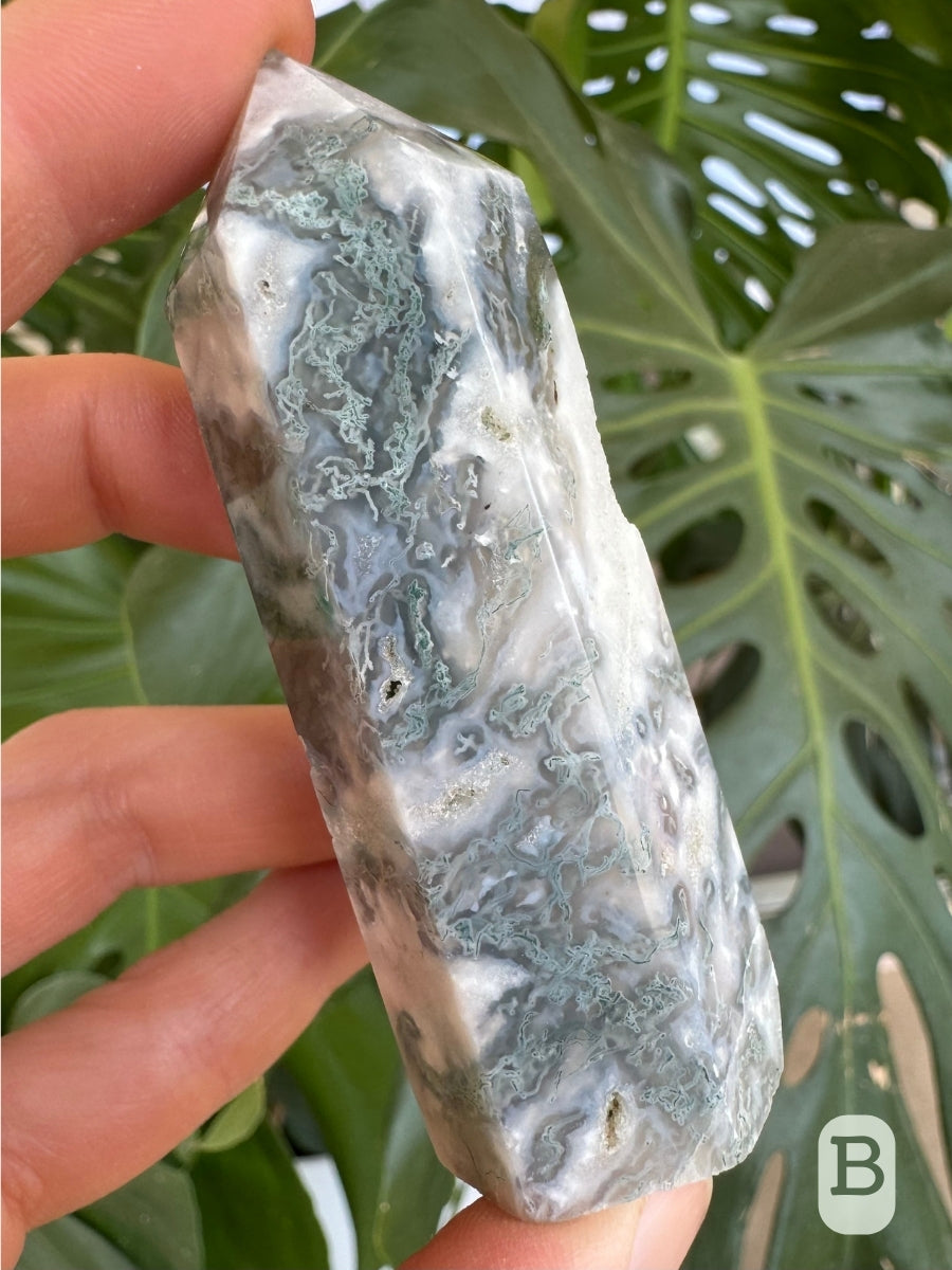 Option B, a side of the tower that is mostly white with light minty green inclusions snaking through it, and translucent agate with an almost lavender tint.