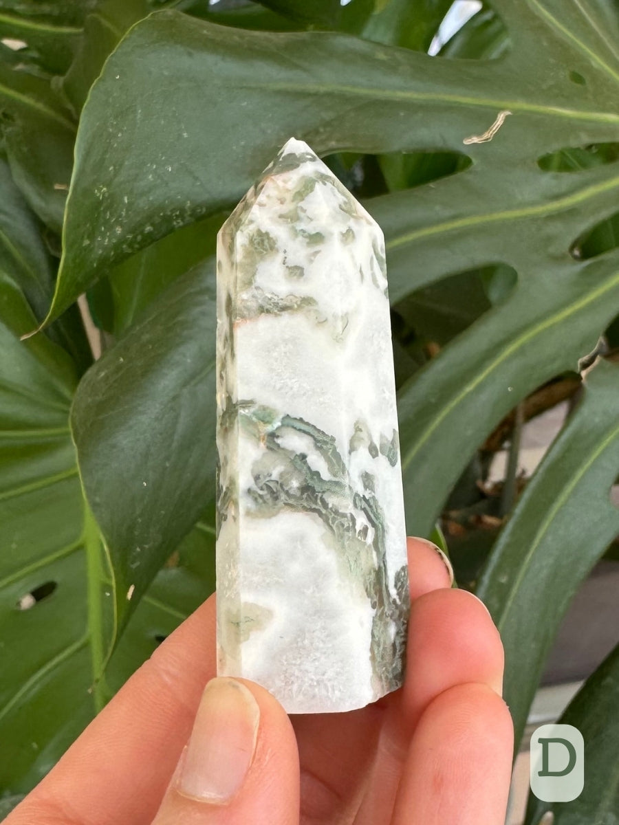 Option D, white agate with snaking green mossy inclusions through it.