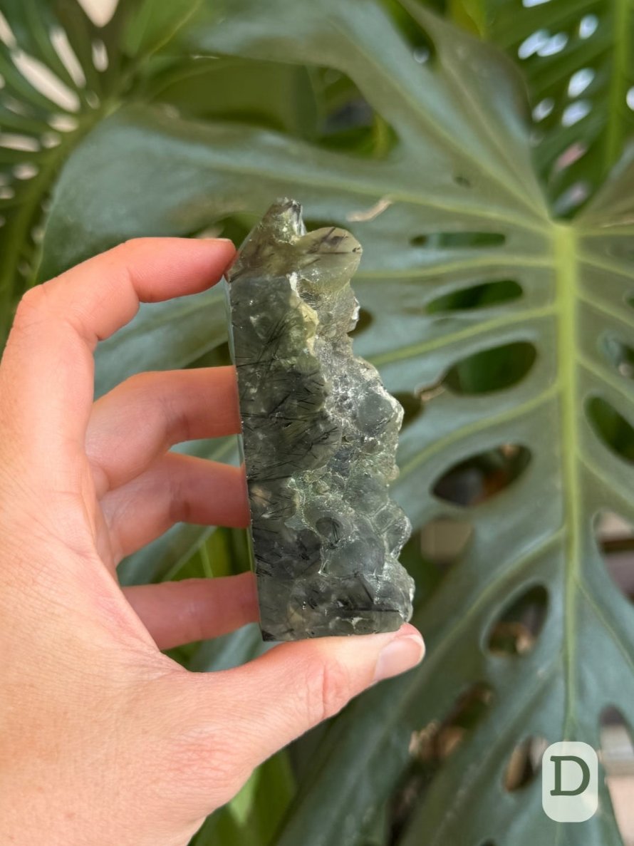 Option D, side-view of the piece, thin on this side as the raw face is slanted. A large sphere juts out near the tip, which is half missing.