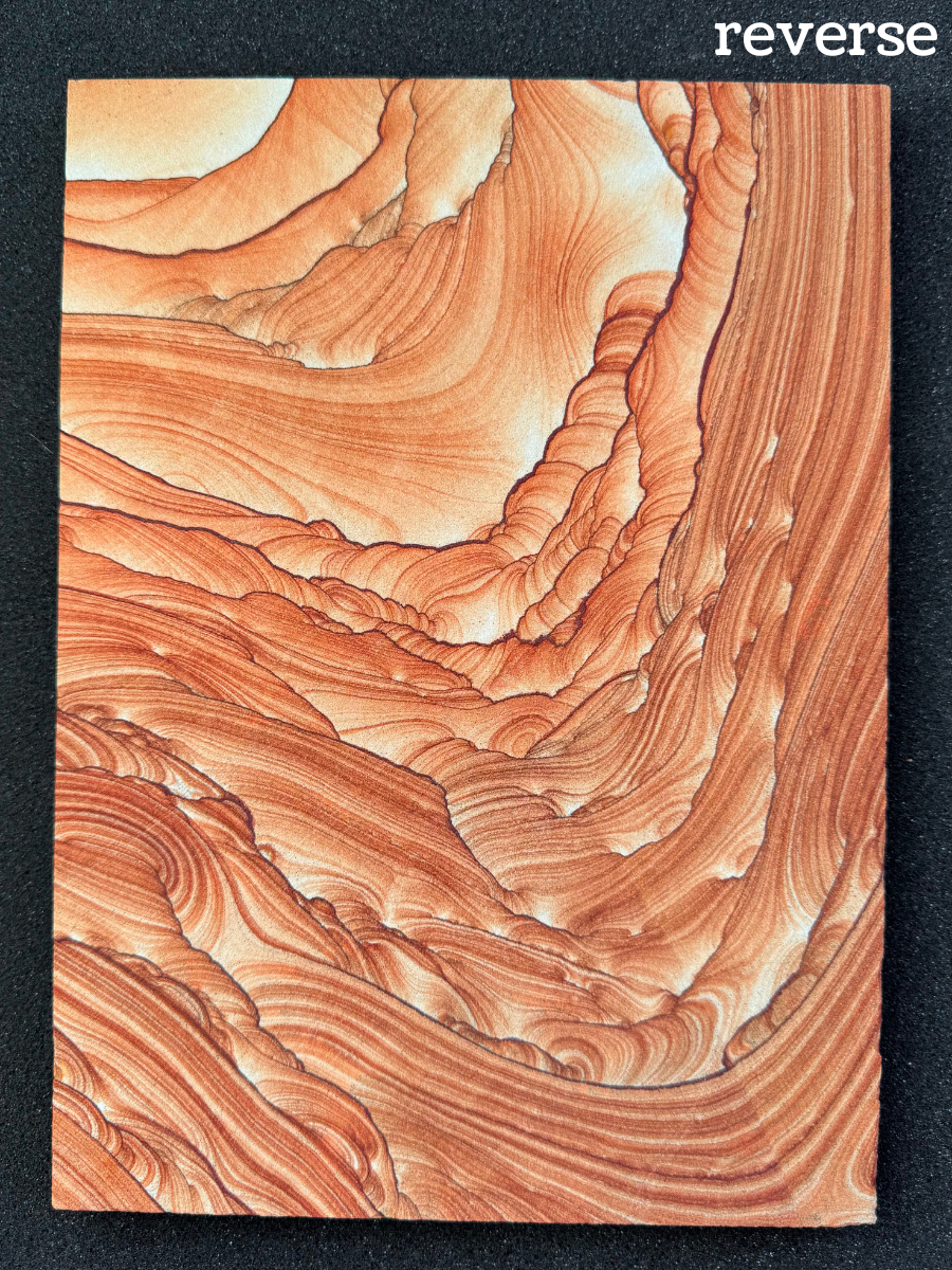Labeled as the reverse of the slab, the pattern is mirror image from the front with slight variations. The color is just as vibrant, but there is a light saw mark across the bottom right.
