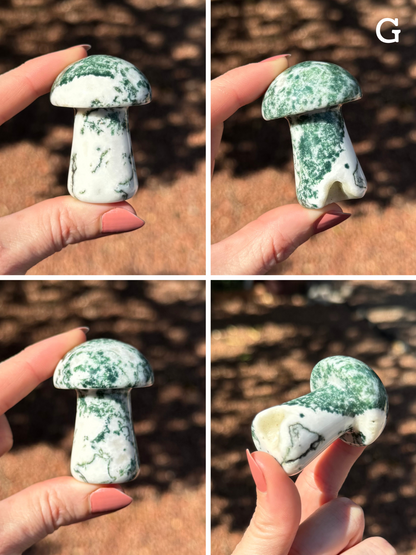 Option G, four views of a mushroom made of more classic moss agate material, white with dark green dendritic splotching and patterns. A small hollow is missing out of the base, creating a geode-like little opening.