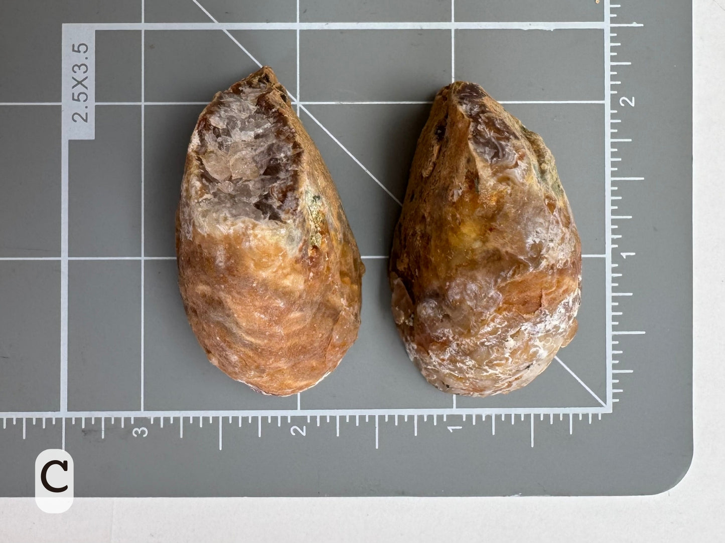 Option C: Scale image of the geode pair face-down on a measuring mat, measuring approximately two inches in diameter.