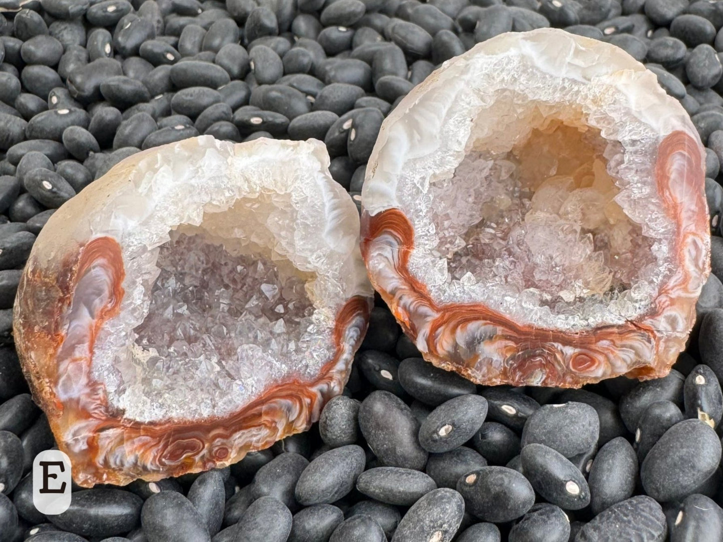 Option E: A round geode pair, half white and half a swirling red-brown and white agate, with the interior lined with colorless quartz.