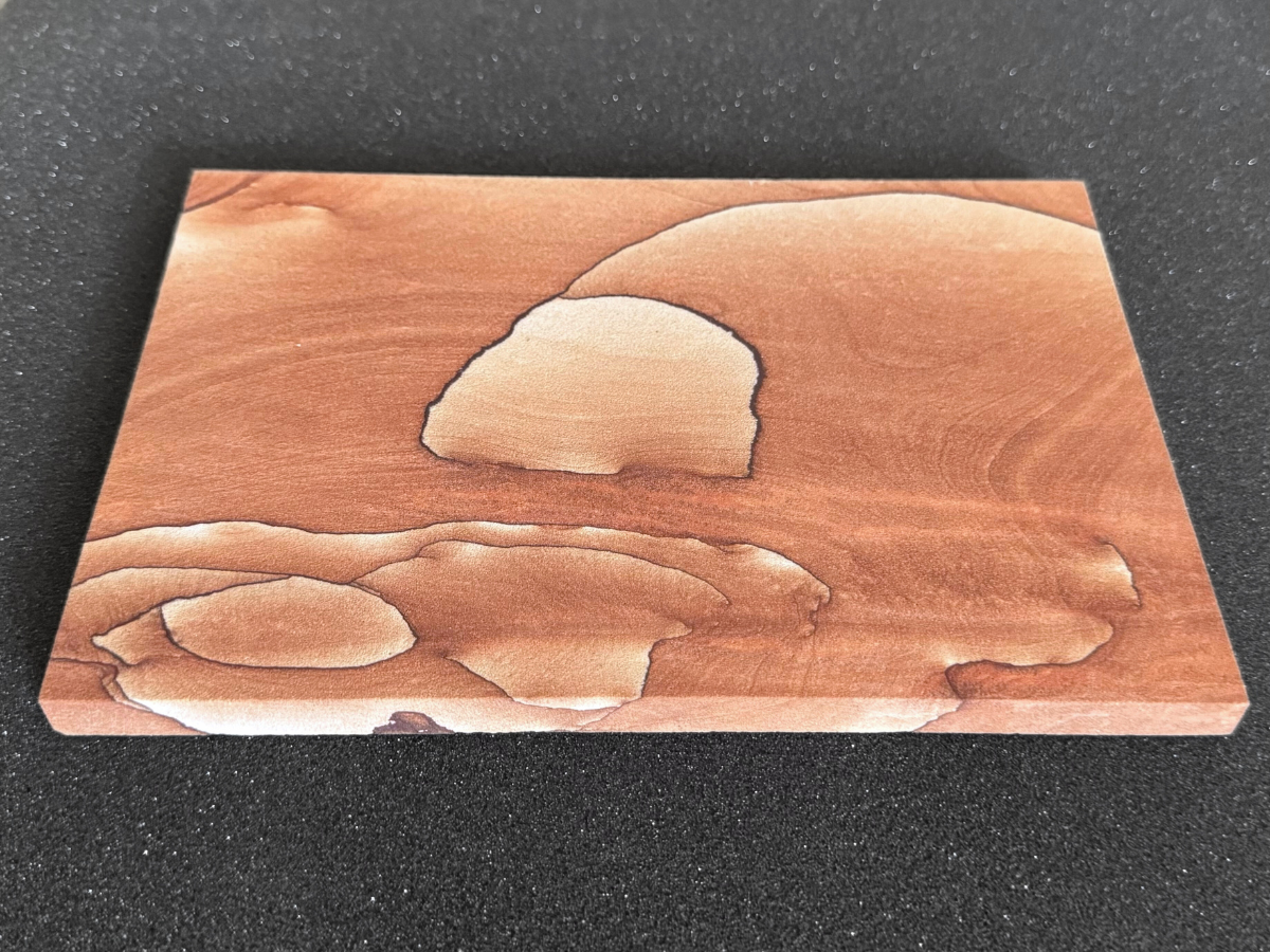 Angled view looking up from the base of the slab, showing the edge is about a centimeter thick.