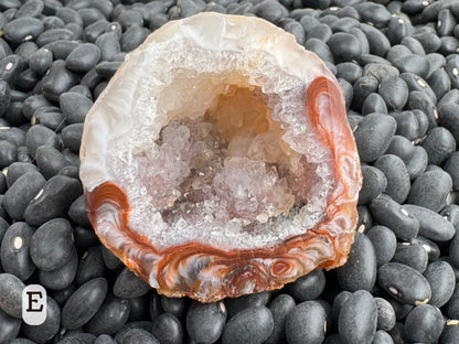 Option E: Detail of the other half of the geode, with mirror-image of the swirling red and white agate pattern and some larger quartz crystals in the interior.