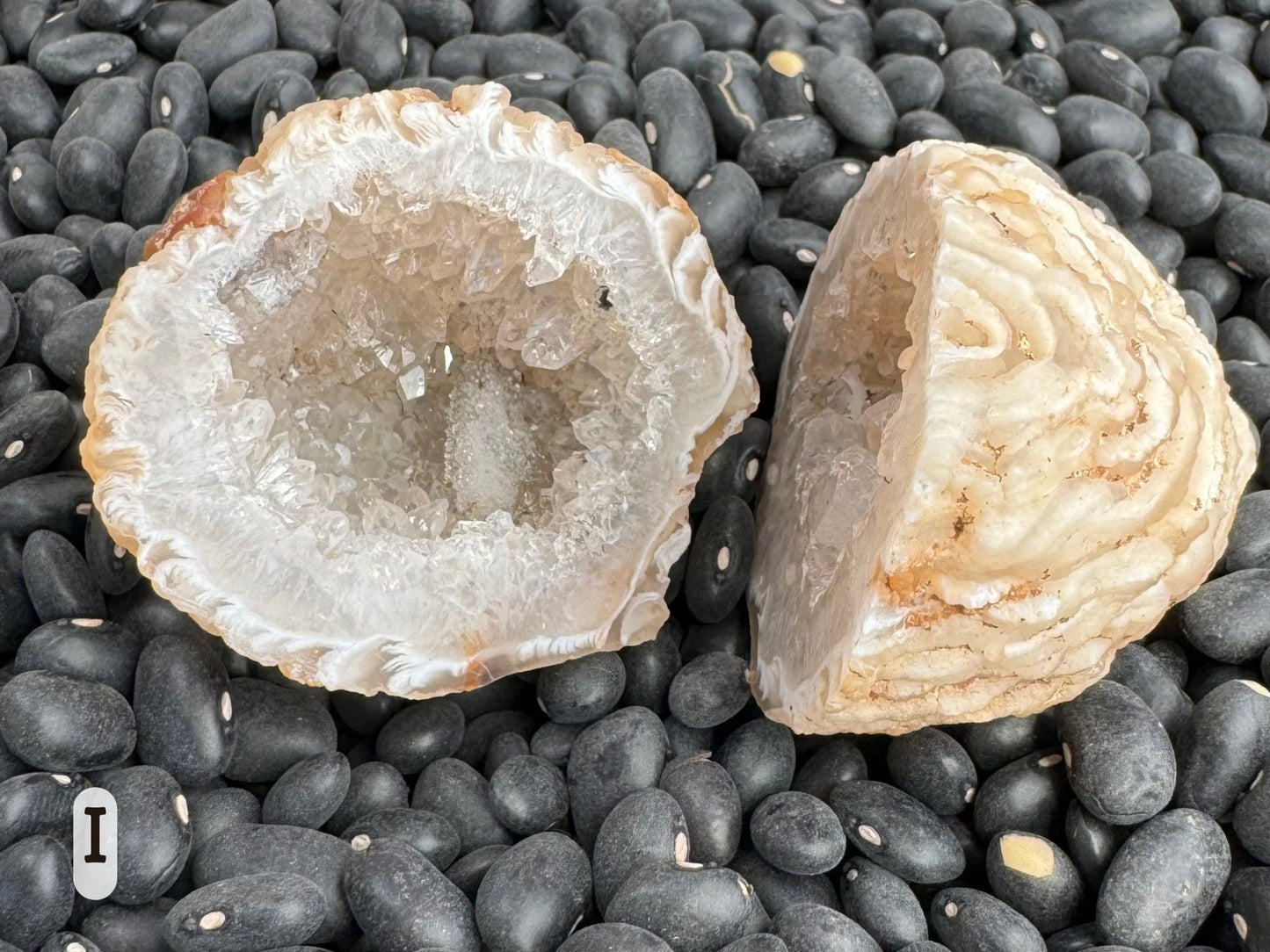 Option I: the geode pair with one side tilted to show the exterior is a pale cream ropy texture.