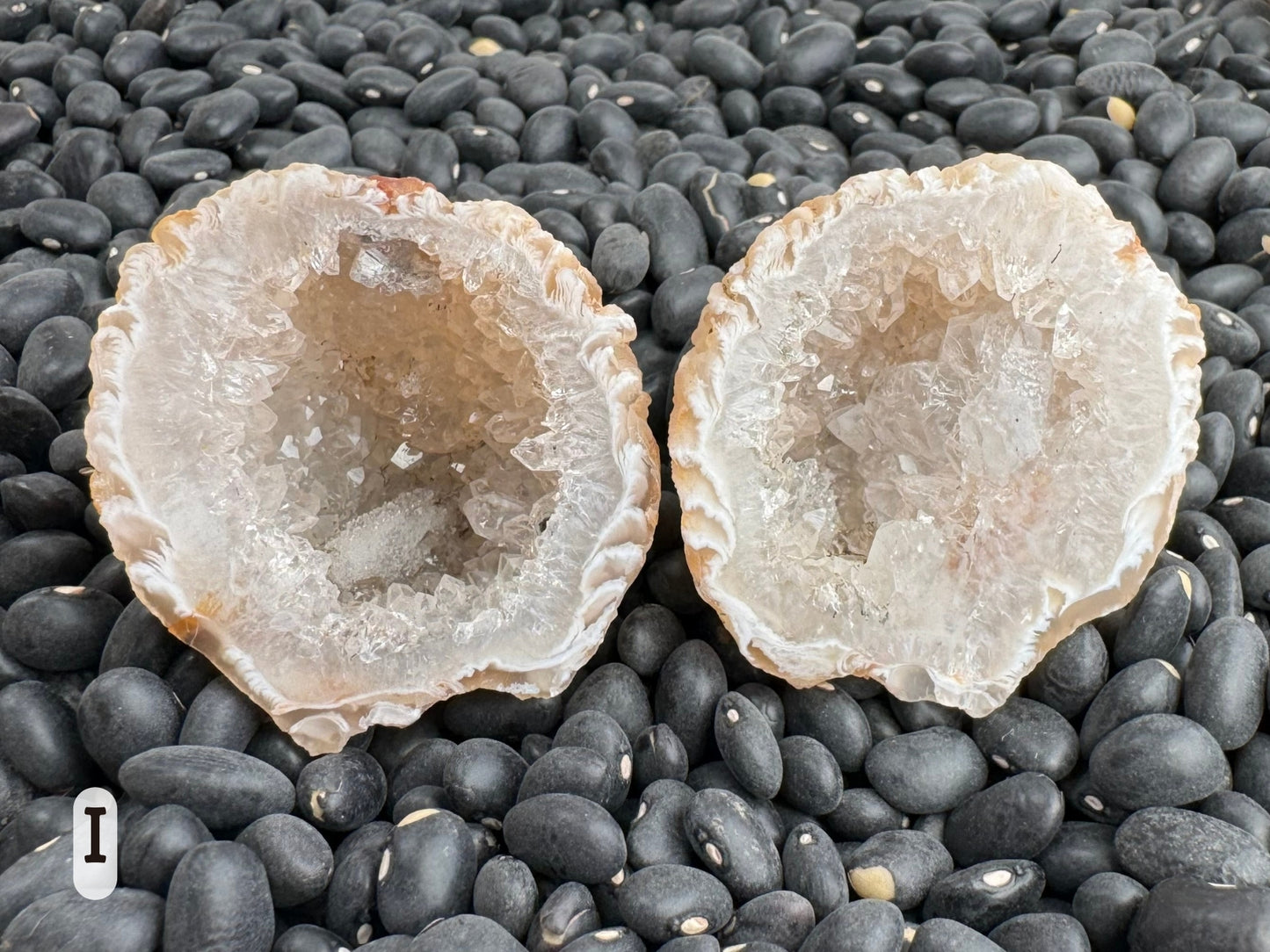 Option I: a round geode pair, the interior filled with a thick layer of colorless quartz crystals and the edge a light feather agate swirl of white and light brown.