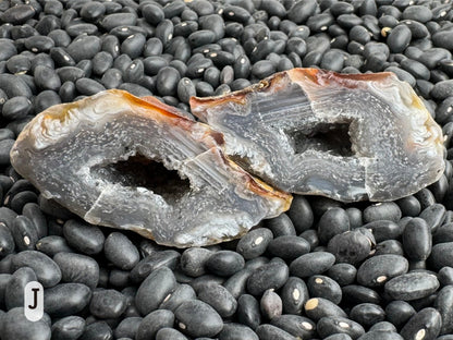 Option J: The geode pair on their side, emphasizing the agate pattern has flat parallel lines on one side versus the swirling pattern around the rest.