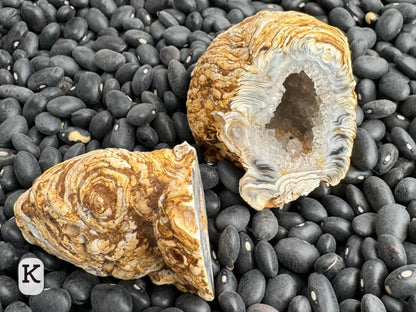 Option K: the geode pair tilted to show the swirls of the interior connect to the swirling ropy pattern on the exterior of the piece.