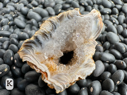 Option K: detail of the other half of the geode, with a thick border of swirling agate reaching the surface.