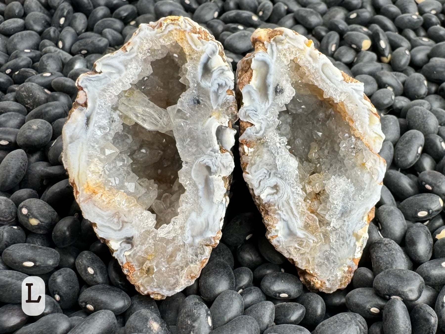 Option L: oval geode pair with white swirling agate edges and the interior lined with colorless quartz.