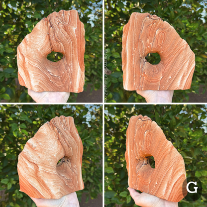 Option G, a blocky arch with one straight edge and the other side curved up to a point. The piece has a lighter orange tone, with a section of pale layering on one side and the other side covered with bold thin layers and rings.
