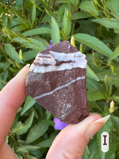 Option I, an irregularly shaped deep red rock that looks like a jasper, criss-crossed with white quartz veins